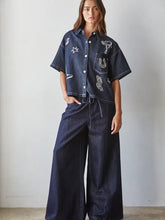 Load image into Gallery viewer, Denim Short Sleeve with western symbols
